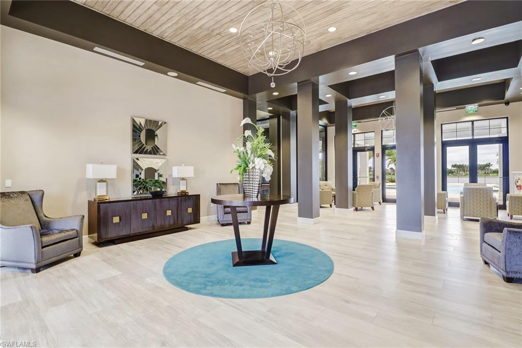 1233 Kendari Terrace Naples, FL 34113 - Photo 32 of 38 a living room with furniture and a wooden floor