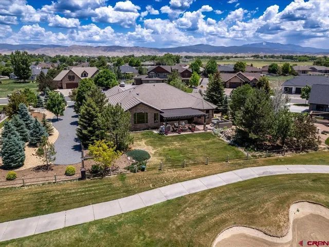an aerial view of residential houses with outdoor space and swimming pool