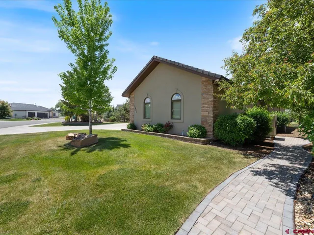 a view of a house with a yard and sitting area
