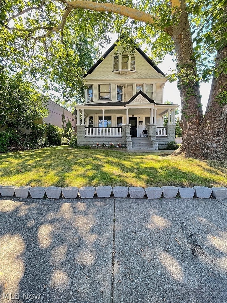 554 Eddy Road Cleveland, OH 44108 - Photo 4 of 32 View of front of house featuring a porch and a front lawn