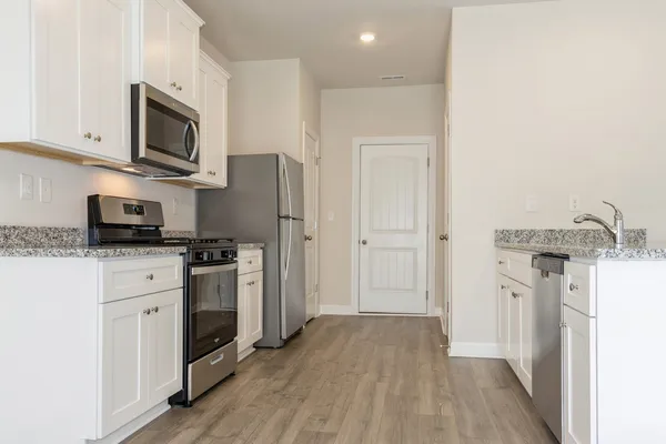 a kitchen with stainless steel appliances a refrigerator stove and sink