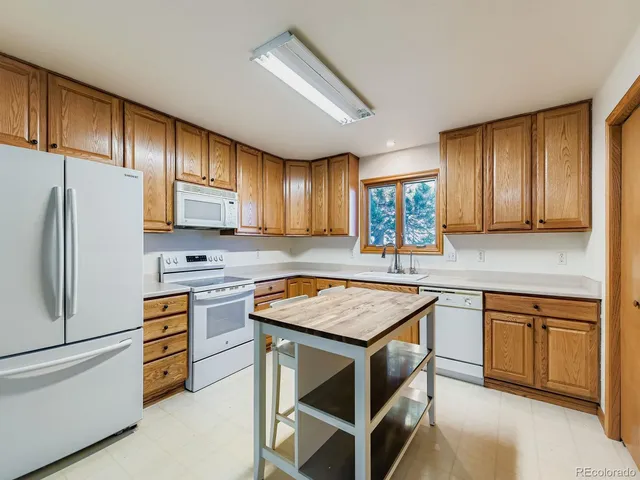 a kitchen with appliances cabinets and furniture