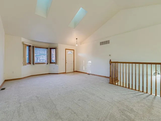 a view of a livingroom with a ceiling fan and window