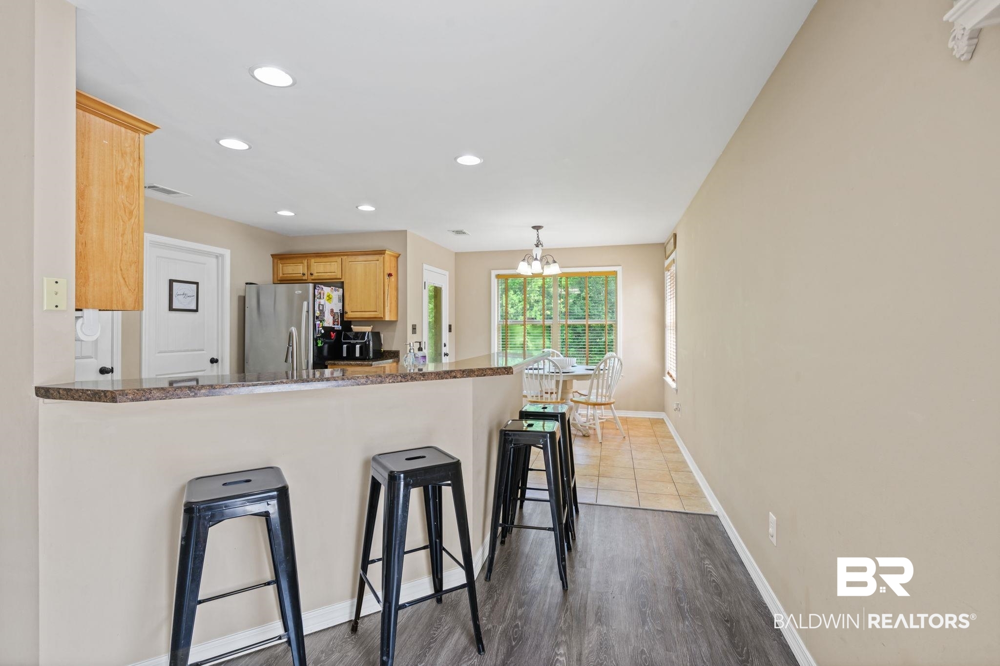 8956 Spring Grove North Mobile, AL 36695 - Photo 6 of 19 Kitchen featuring freestanding refrigerator, a kitchen breakfast bar, baseboards, a chandelier, and recessed lighting