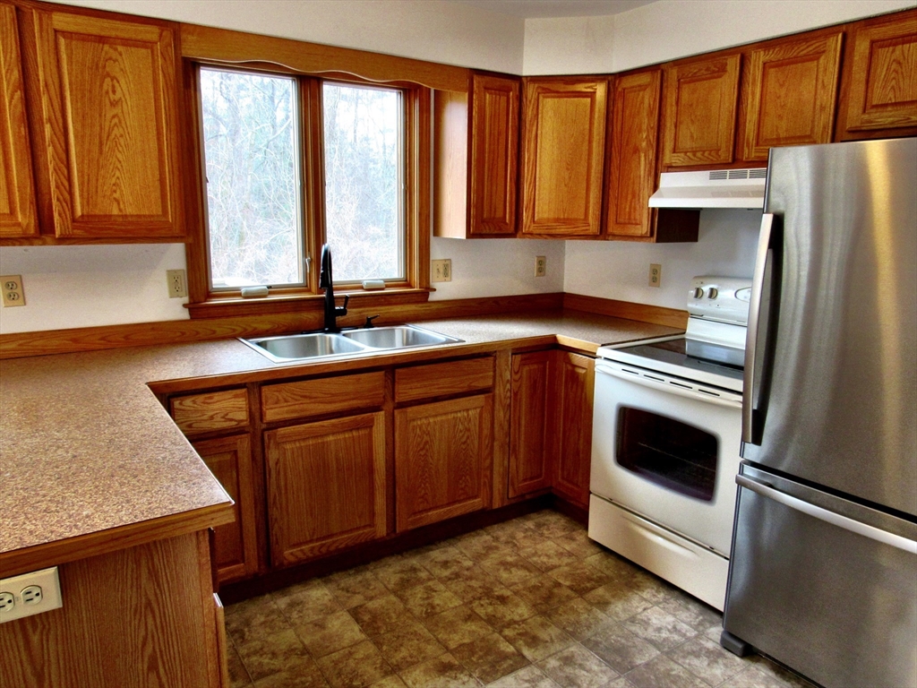 7 Beebe Road Monson, MA 01057 - Photo 12 of 30 a kitchen with stainless steel appliances granite countertop a refrigerator sink and cabinets