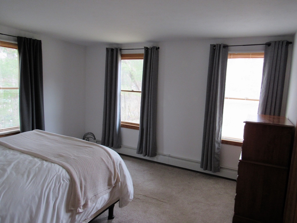 7 Beebe Road Monson, MA 01057 - Photo 13 of 30 a bed sitting in a bedroom next to a window