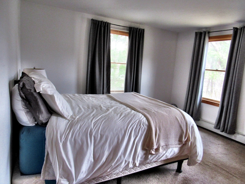 7 Beebe Road Monson, MA 01057 - Photo 14 of 30 a bed sitting in a bedroom next to a window