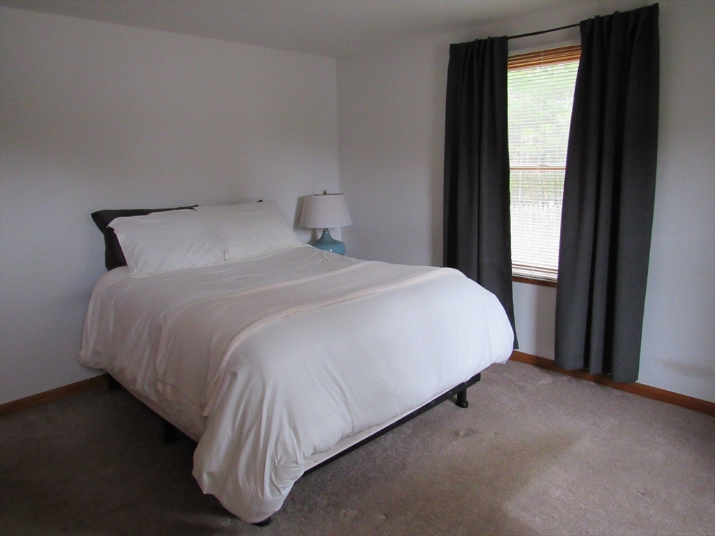7 Beebe Road Monson, MA 01057 - Photo 15 of 30 a bed sitting in a bedroom next to a window