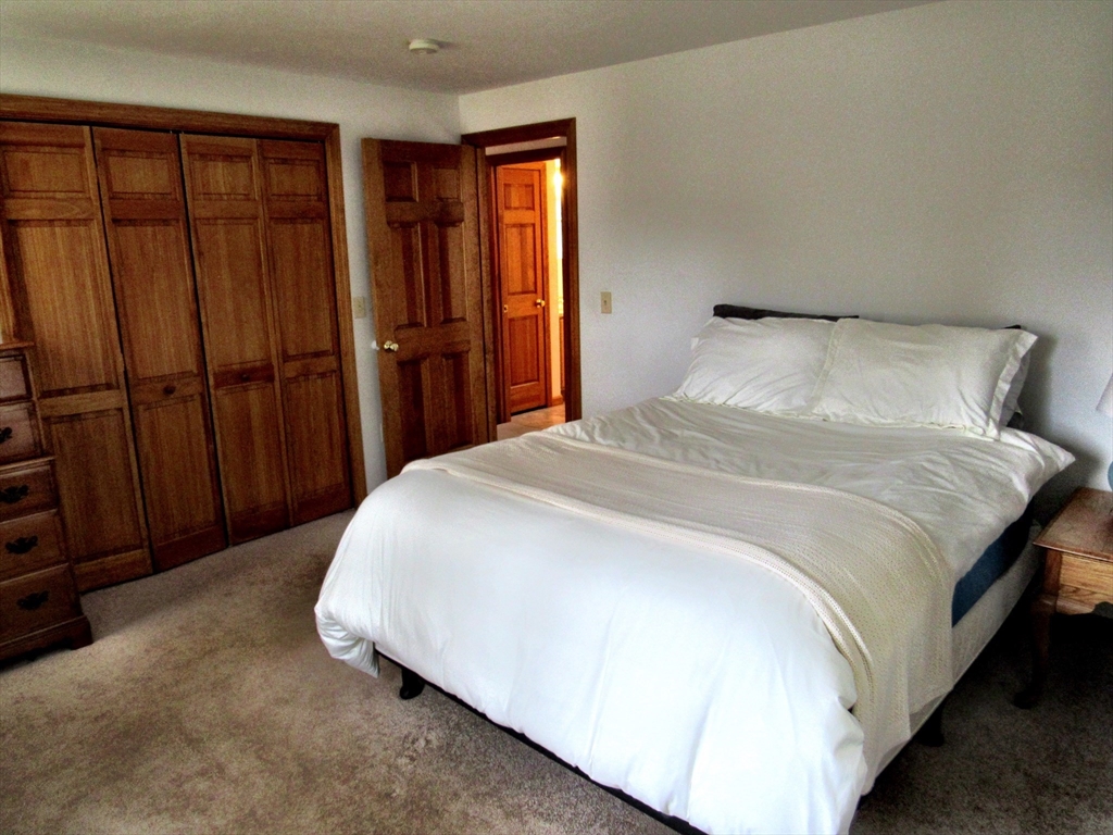 7 Beebe Road Monson, MA 01057 - Photo 16 of 30 a bedroom with a bed closet and wooden floor