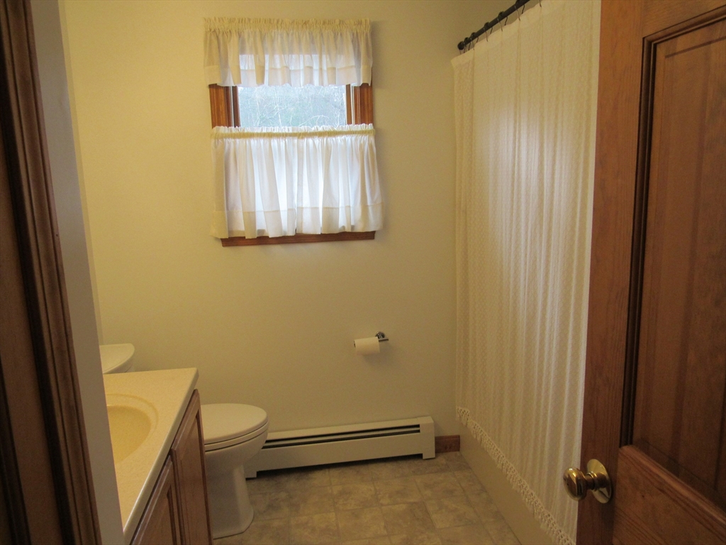 7 Beebe Road Monson, MA 01057 - Photo 20 of 30 a bathroom with a window and toilet