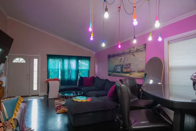 a living room with furniture and wooden floor