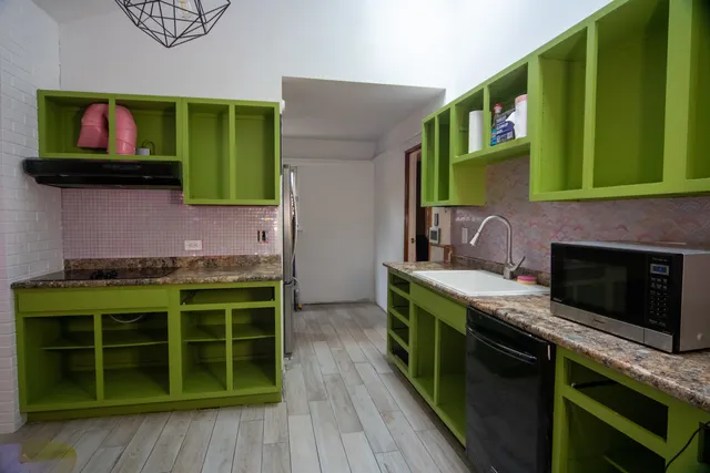 a kitchen with stainless steel appliances a stove a sink and a microwave