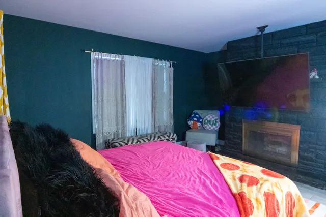 a bedroom with a bed and a dresser