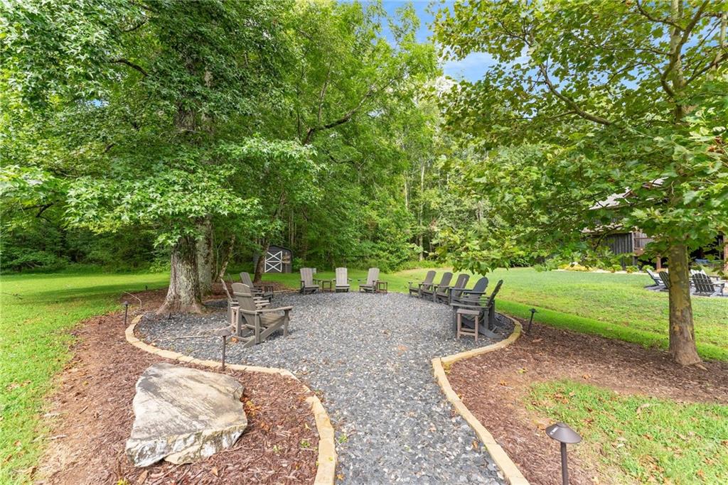 253 Happy Trails Way Jasper, GA 30143 - Photo 20 of 97 a backyard of a house with yard and outdoor seating
