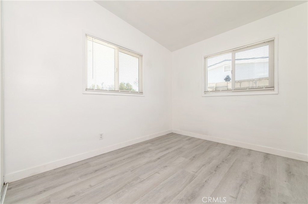 833 North Eldon Avenue La Puente, CA 91744 - Photo 13 of 20 an empty room with wooden floor and windows