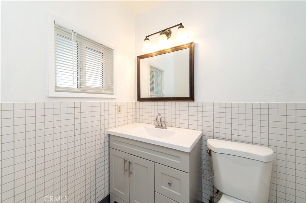 833 North Eldon Avenue La Puente, CA 91744 - Photo 15 of 20 a bathroom with a toilet sink vanity and mirror