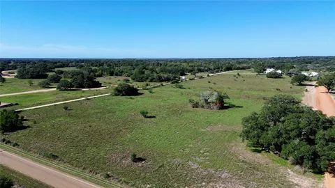 a view of a field with an ocean view