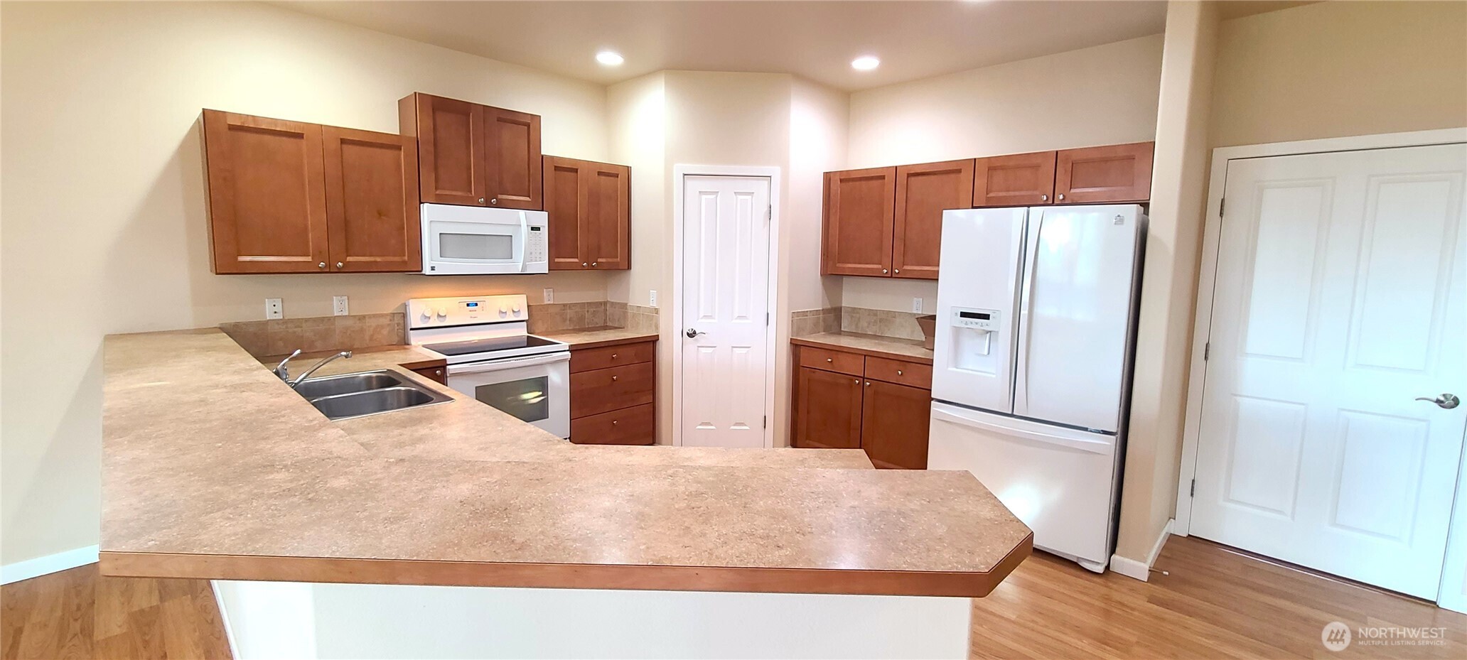 50 Goldenrod Lane Sequim, WA 98382 - Photo 11 of 24 a kitchen with stainless steel appliances kitchen island granite countertop a refrigerator and a sink