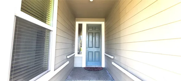 a view of a door and wooden floor
