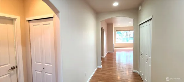 a view of a room with wooden floor and a bathroom