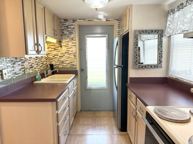 7701 Starkey Road, Unit 731 Seminole, FL 33777 - Photo 3 of 19 a kitchen with a sink stove and refrigerator