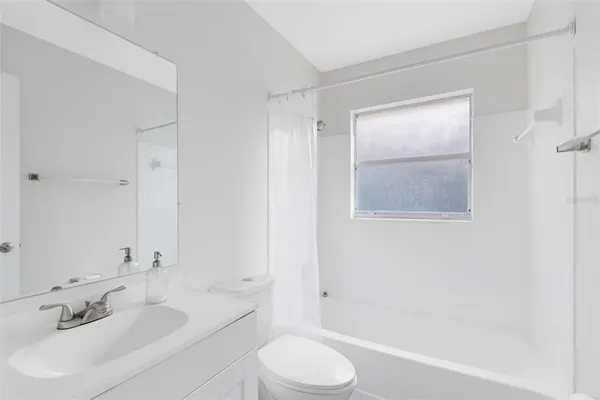 a bathroom with a toilet a sink and bathtub