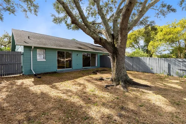 a view of a house with a tree in the background
