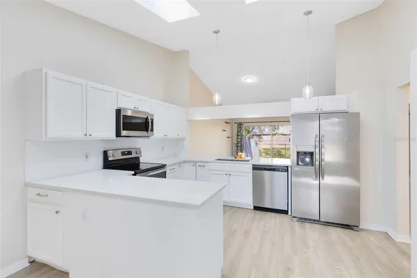 a kitchen with refrigerator cabinets and microwave