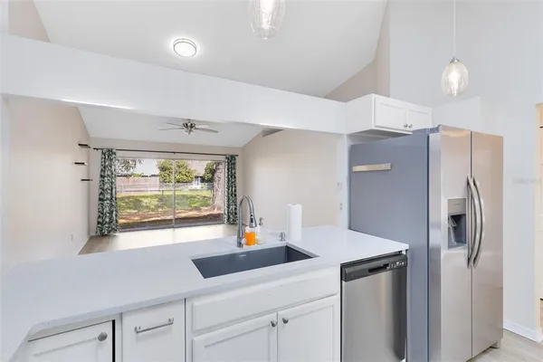 a kitchen with stainless steel appliances a sink and a refrigerator