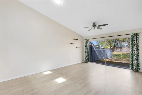 an empty room with large windows