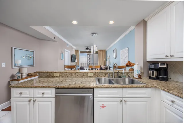 a kitchen with stainless steel appliances granite countertop a sink and cabinets