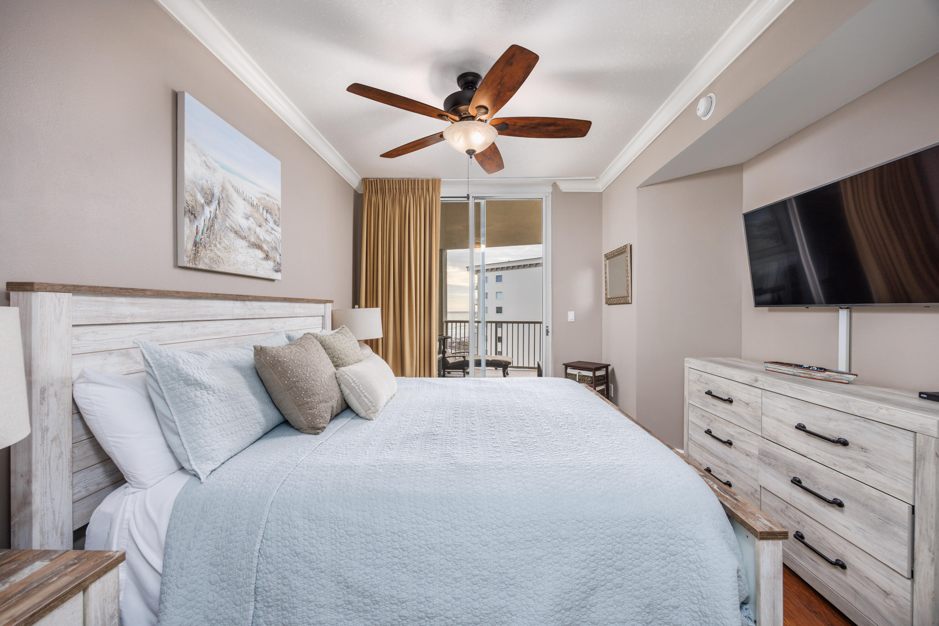 1150 Santa Rosa Boulevard, Unit 421 Fort Walton Beach, FL 32548 - Photo 13 of 46 a bedroom with a large bed and a flat tv screen on dresser