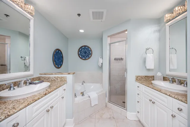 a bathroom with a granite countertop sink mirror and toilet
