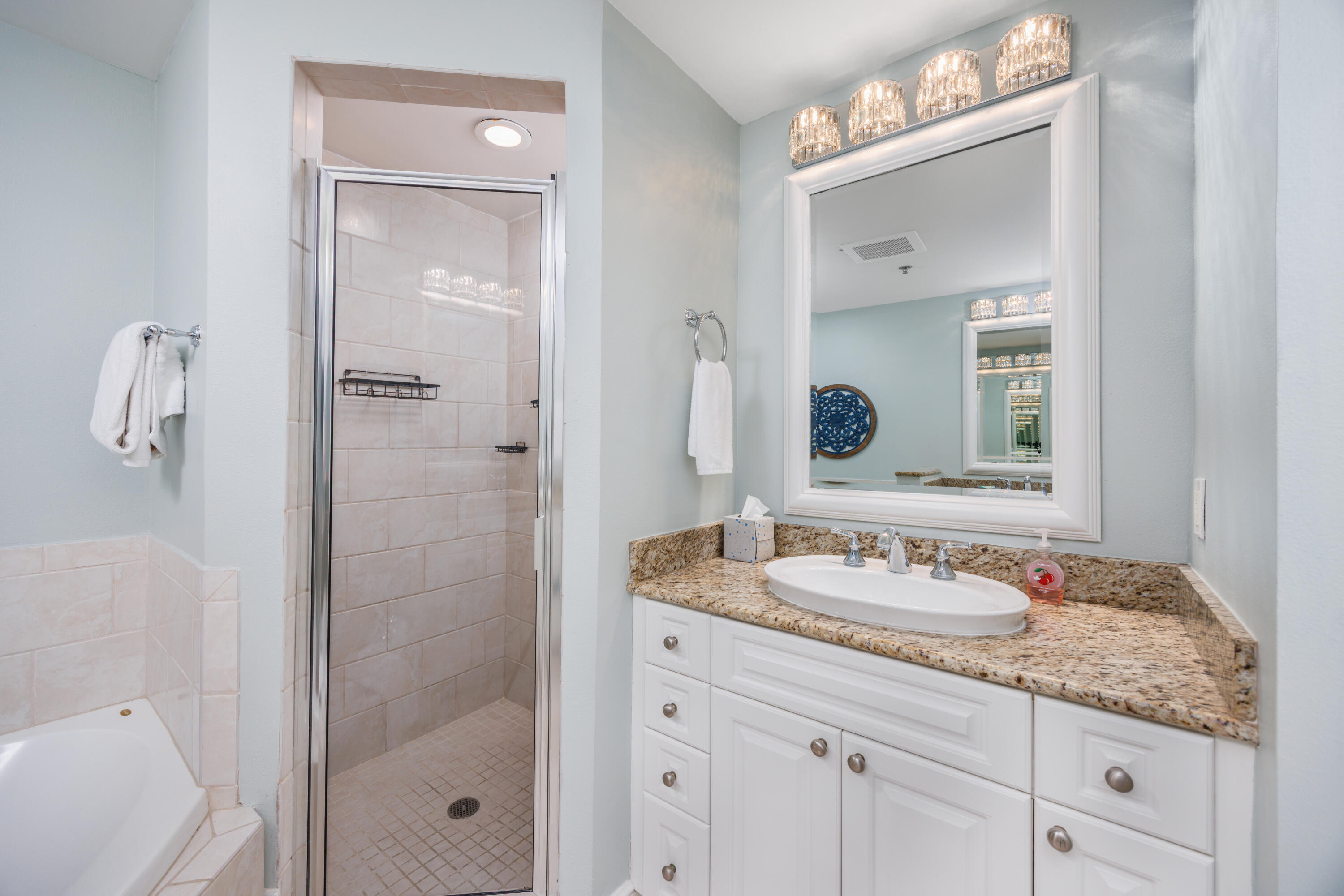 1150 Santa Rosa Boulevard, Unit 421 Fort Walton Beach, FL 32548 - Photo 16 of 46 a bathroom with a granite countertop sink two mirror and shower