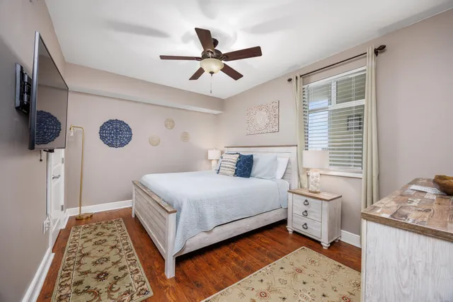 a bedroom with a bed and a lamp on dresser