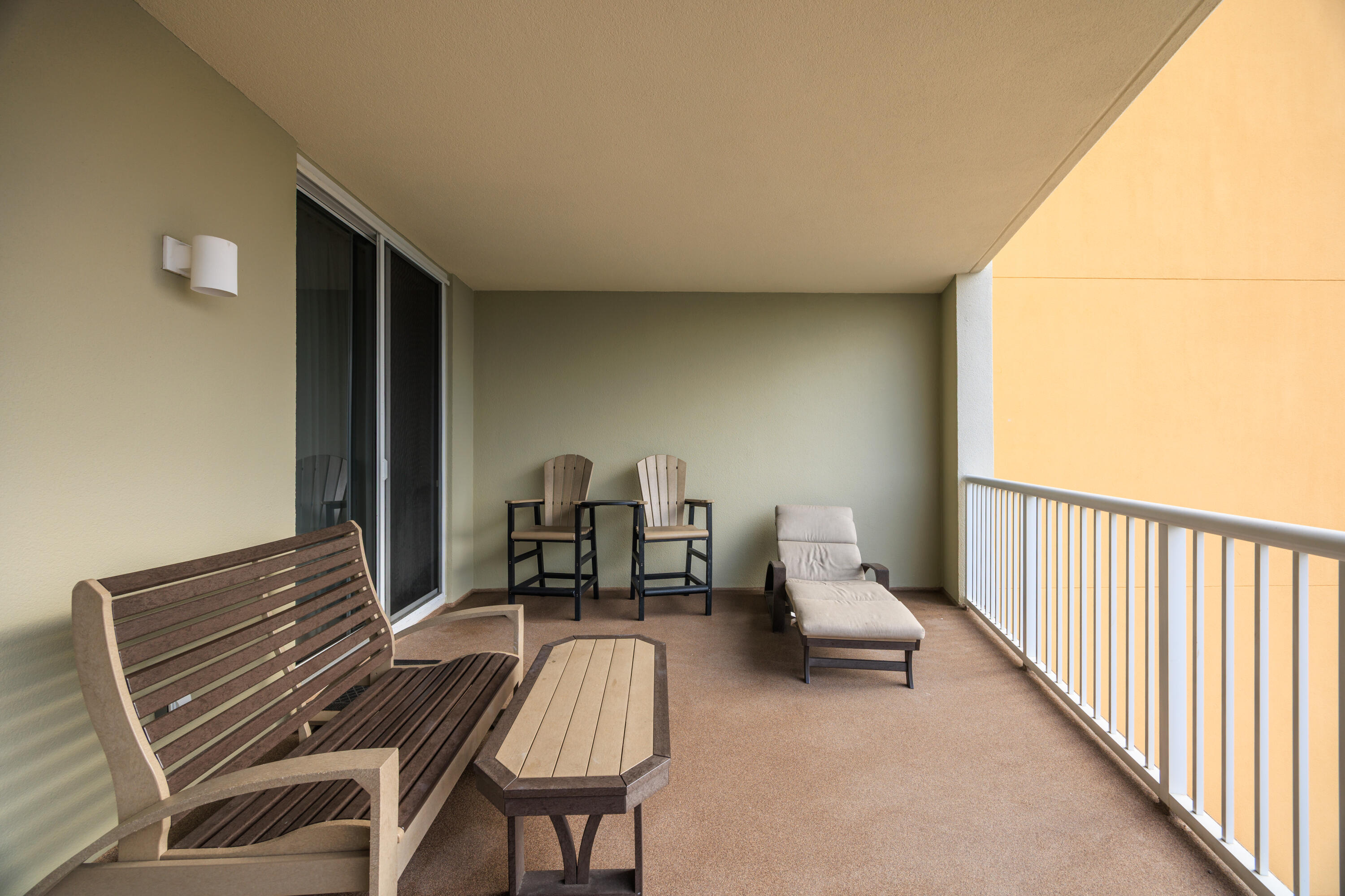 1150 Santa Rosa Boulevard, Unit 421 Fort Walton Beach, FL 32548 - Photo 28 of 46 a balcony with chairs and wooden floor