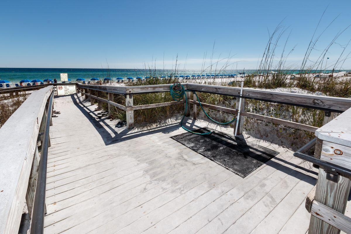 1150 Santa Rosa Boulevard, Unit 421 Fort Walton Beach, FL 32548 - Photo 35 of 46 a view of a roof deck with wooden floor and fence