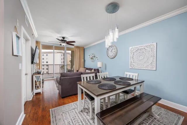 a living room with furniture a rug and a chandelier