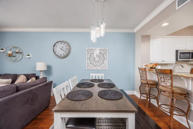 a living room with furniture and kitchen