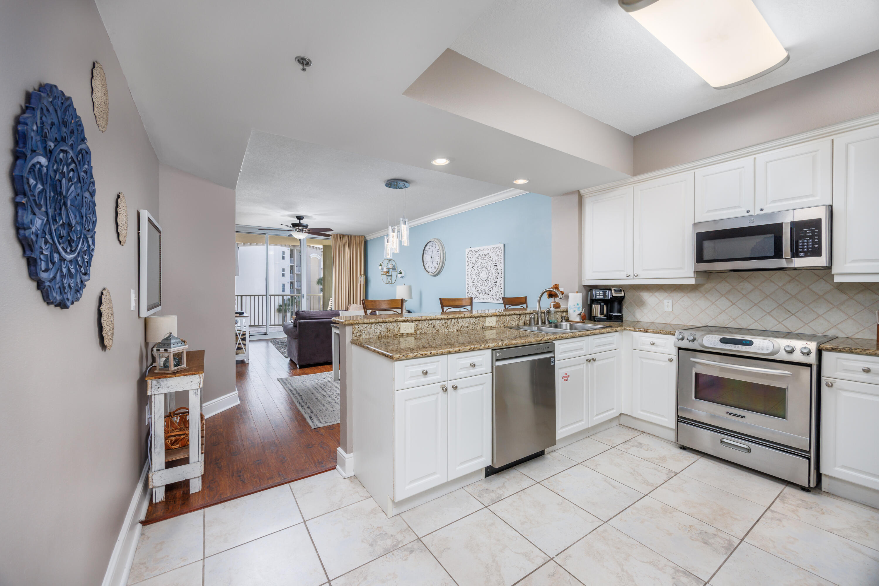 1150 Santa Rosa Boulevard, Unit 421 Fort Walton Beach, FL 32548 - Photo 8 of 46 a kitchen with stainless steel appliances granite countertop a refrigerator sink and microwave