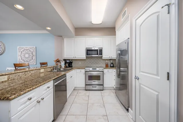 a kitchen with a stove a sink and a refrigerator