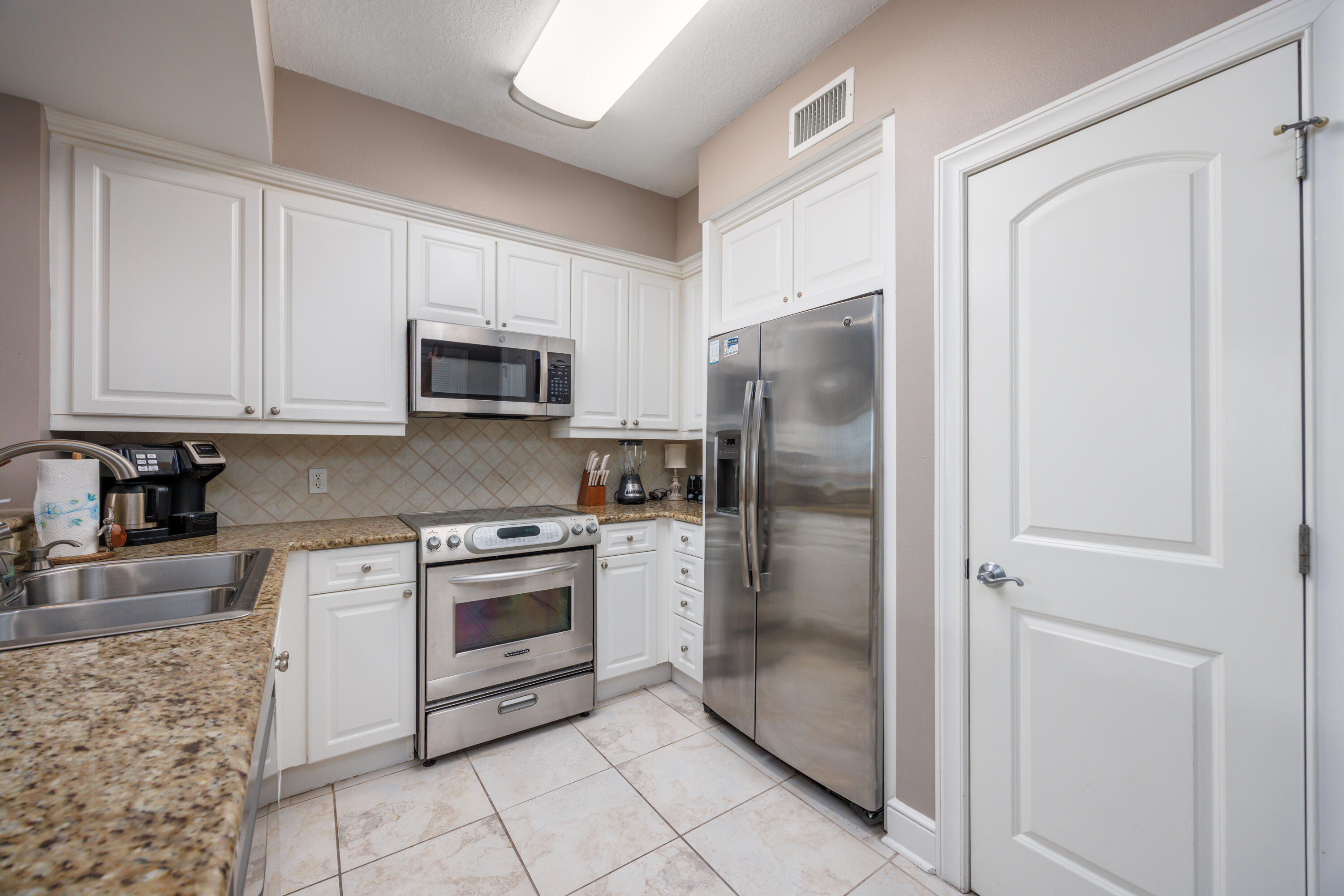 1150 Santa Rosa Boulevard, Unit 421 Fort Walton Beach, FL 32548 - Photo 10 of 46 a kitchen with stainless steel appliances granite countertop a refrigerator stove and sink