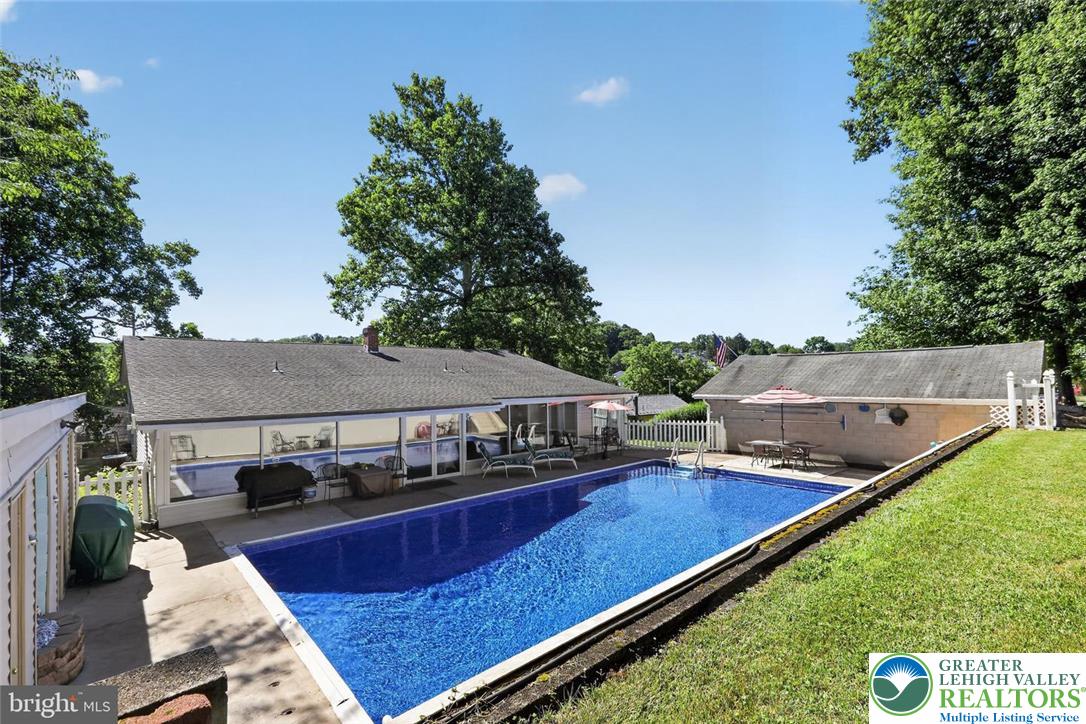 740 Public Road Bethlehem, PA 18015 - Photo 8 of 40 An inviting backyard oasis offers a vibrant in-ground pool and ample space for outdoor enjoyment.