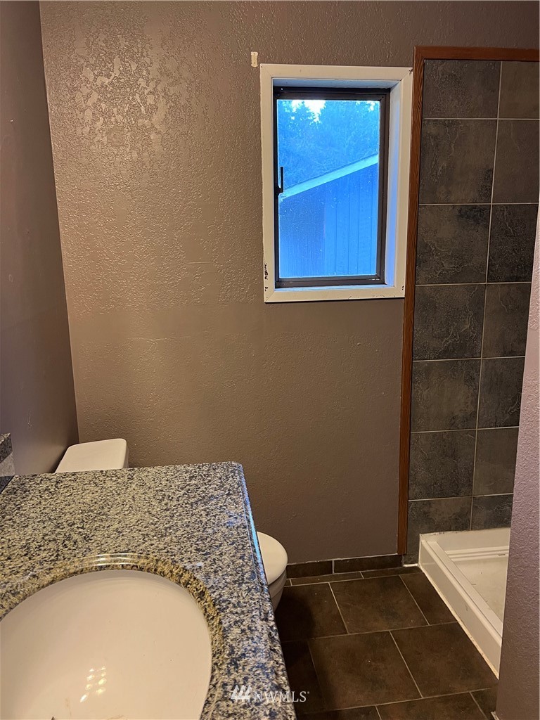 2163 O Brien Road Port Angeles, WA 98362 - Photo 8 of 24 a bathroom with a granite countertop sink and a mirror