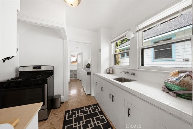 a kitchen with a sink and a stove top oven