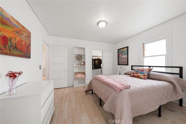 a bedroom with a bed and a large mirror