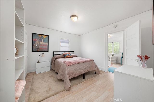 a bedroom with a bed and a large mirror