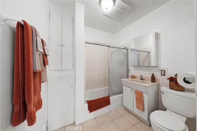 a bathroom with a toilet sink and shower