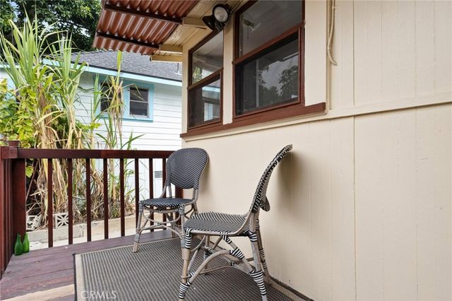 a view of a porch with chairs and backyard