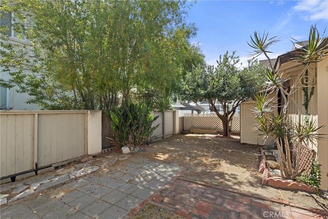 a view of a house with a tree in the background